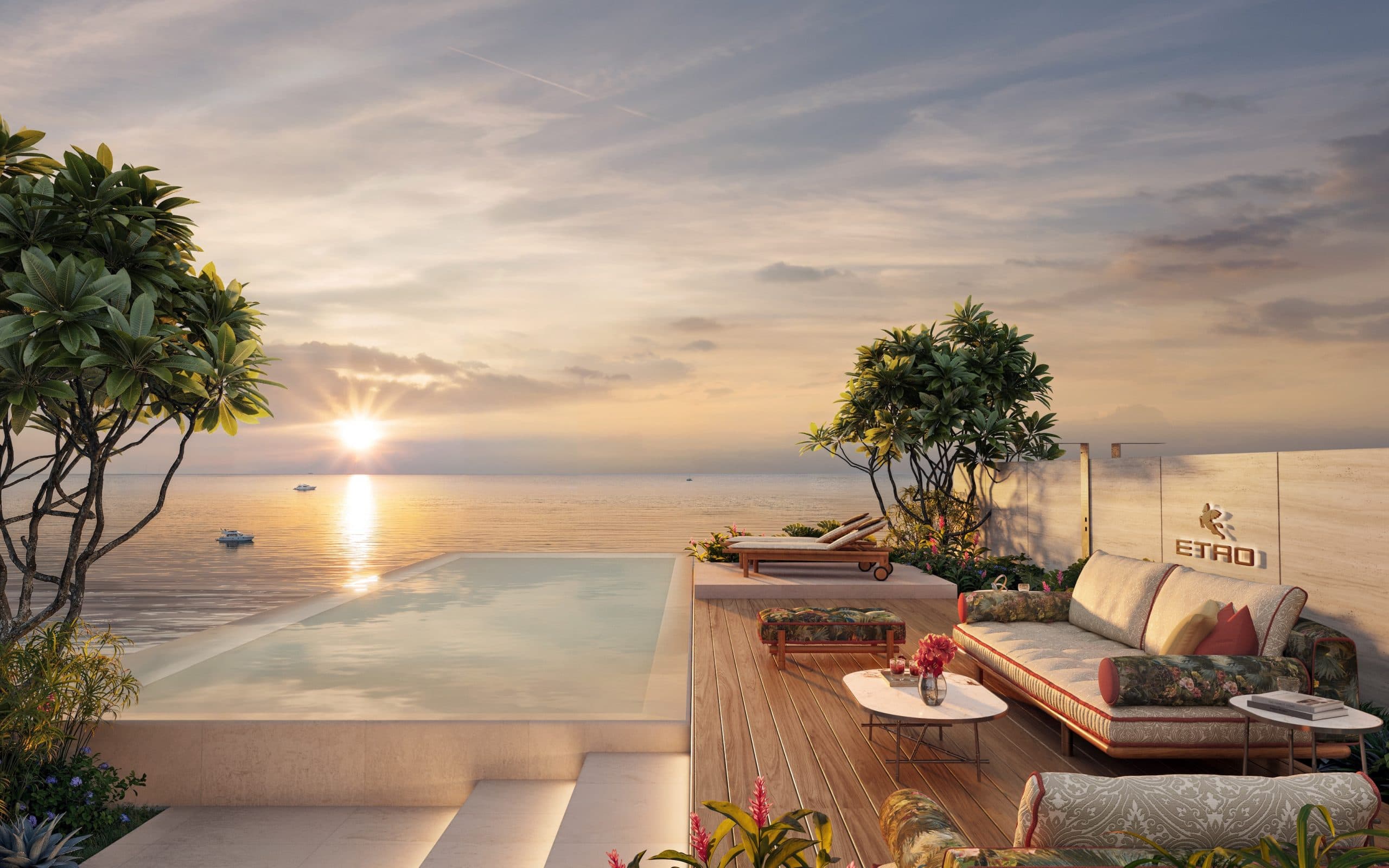 Rooftop-Lounge und Pool der ETRO Residences Phuket beim Sonnenuntergang mit Blick aufs Meer, luxuriöses Möbeldesign.