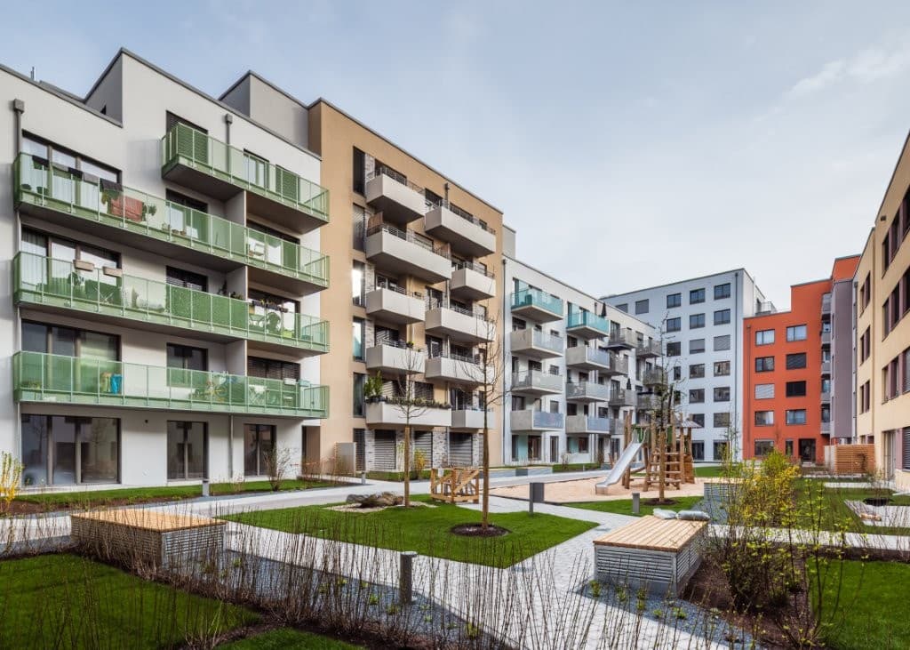 Moderne Wohnanlage in Nürnberg mit grünen Balkonen und Innenhof.