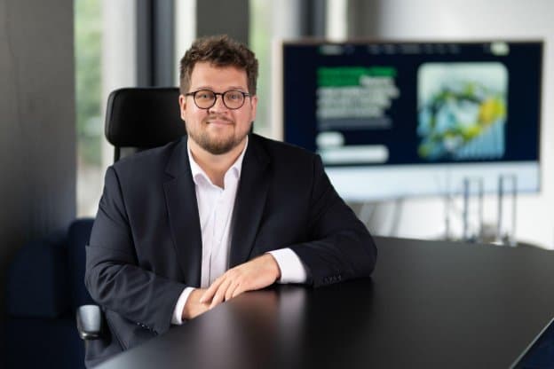 Bernardas Preikšaitis, CEO von InRento, sitzt an einem Tisch im Büro.