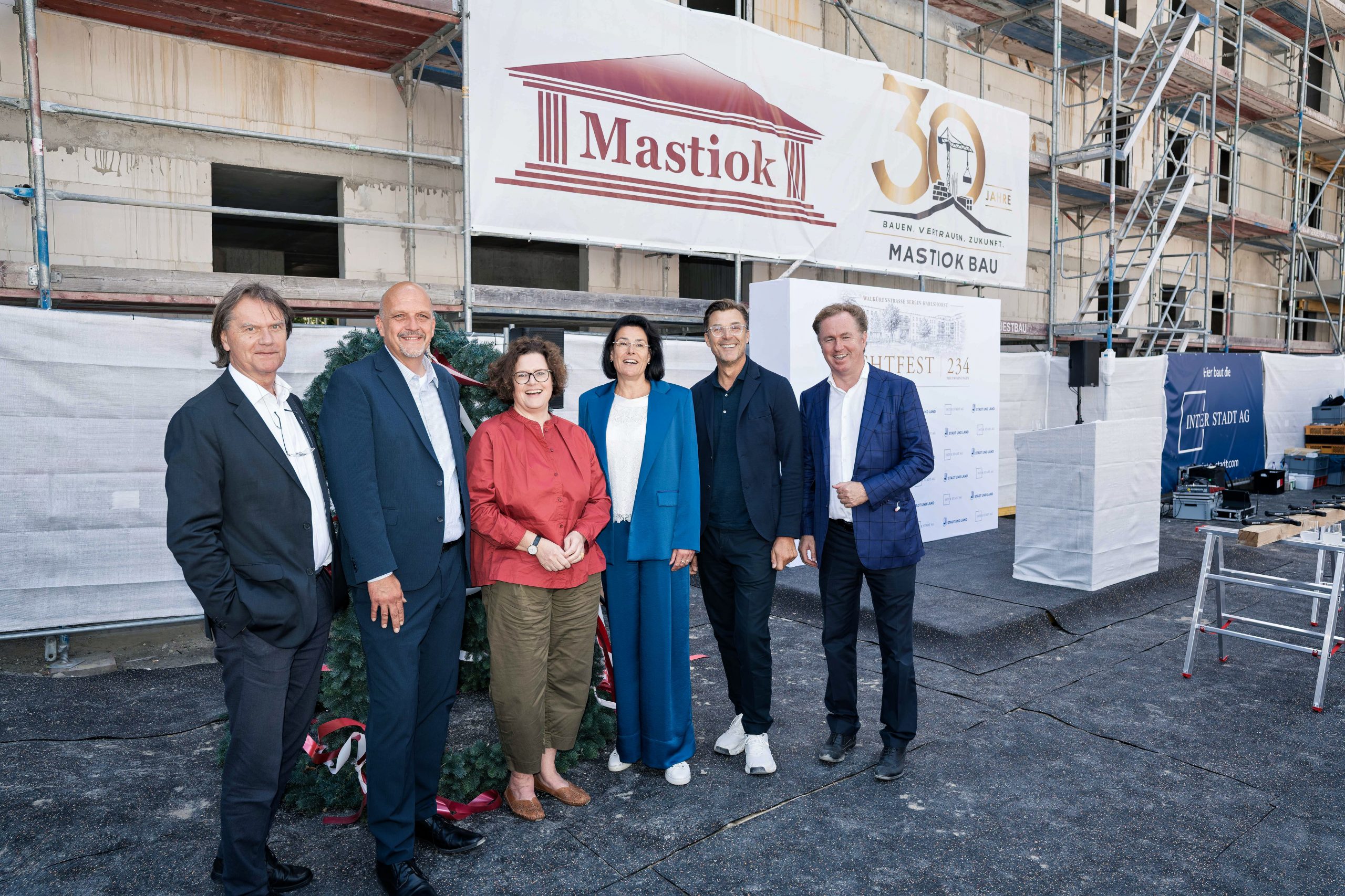 Gruppenfoto der Projektbeteiligten beim Richtfest in Berlin-Karlshorst vor dem Bauprojekt Walkürenstraße.